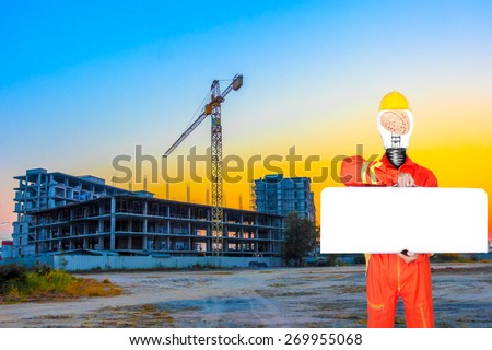technician have brain inside a light bulb in uniform holding toolbox blank for work space at building construction site against beautiful sky sunset