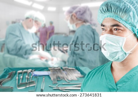 close up image of mature male surgeon with equipment tools for surgeons who need to operate a patient in an operation room arranged on a table for a surgery of surgeon in operating room