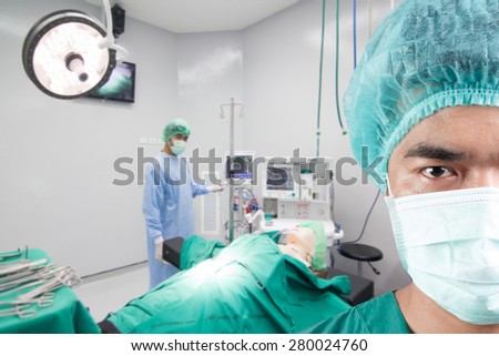 closed up image of surgeon with team and equipment tools for surgeons arranged on a table in operating room