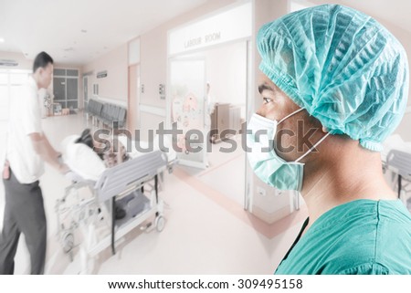 side view image of mature male surgeon and medical active staff pushing stretcher gurney bed in labour room of hospital corridor with female patient pregnant in emergency status