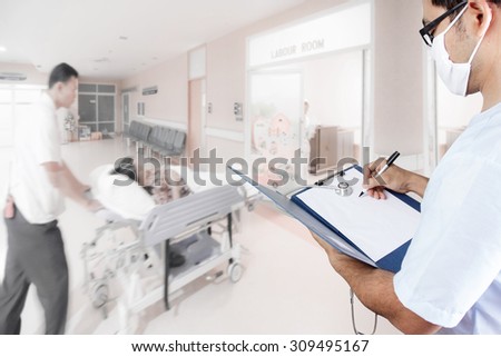 Doctor writing clipboard for diagnosis and medical active staff pushing stretcher gurney bed in labour room of hospital corridor with female patient pregnant in emergency status