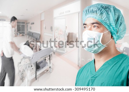 surgeon in medical clothes and medical active staff pushing stretcher gurney bed in labour room of hospital corridor with female patient pregnant in emergency status