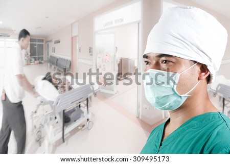 Mature male surgeon in medical clothes and medical active staff pushing stretcher gurney bed in labour room of hospital corridor with female patient pregnant in emergency status