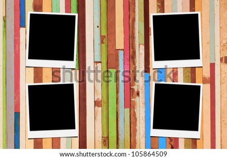 Blank instant photo frames on wooden background.