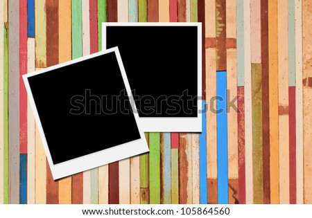Blank instant photo frames on wooden background.
