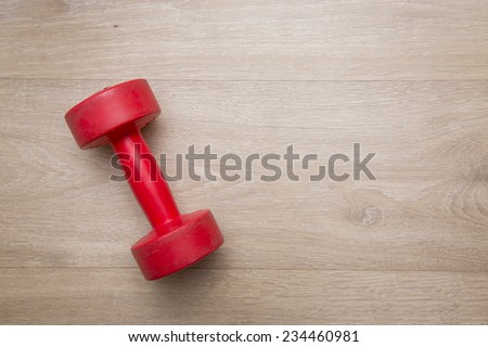 dumbbell on wood background with space for text