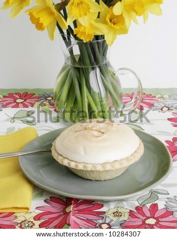 Meringue pie and vase of flowers