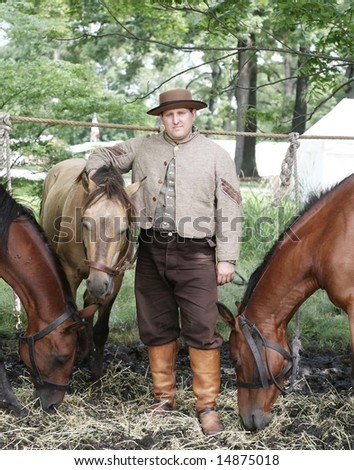 Actor in costume with his horses for re-enactment of civil war
