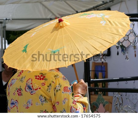 Lady holding a yellow chinese umbrella