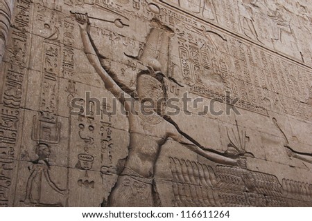 Hieroglyhic carvings on an ancient egyptian temple wall in Luxor