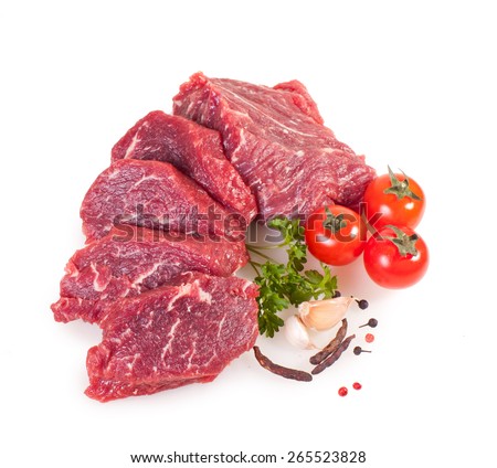 Raw pieces of crude meat with vegetables isolated on white background