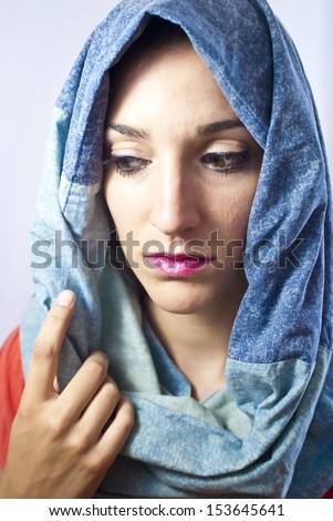 Portrait of a young  woman with scarf over head