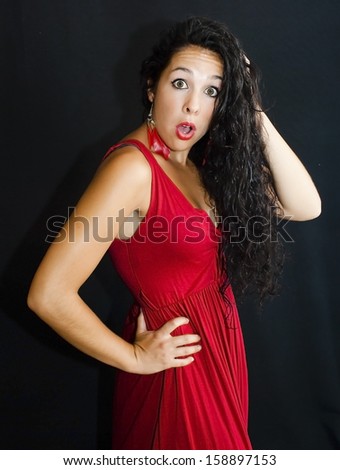 Wonderful latin woman with red dress on black background