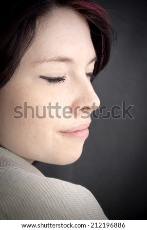 Portrait of Beautiful Young Woman with a red tuft Over Black Background