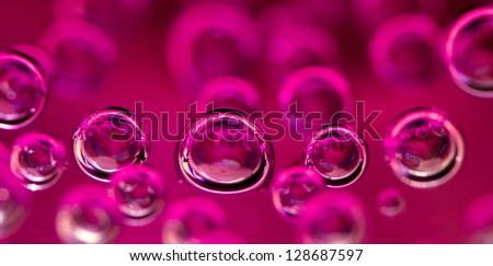 Air bubbles in pink water. Macro