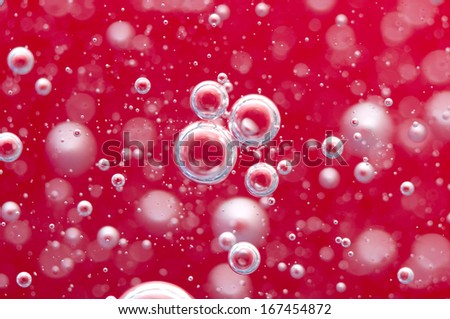 Air bubbles in a liquid. Abstract red background. Macro