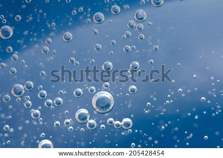 Air bubbles in a liquid. Abstract blue background. rather unique macro photo, for your  successful business design.  Macro
