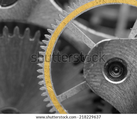 Black  white metallic Background with golden strip on cogwheel a clockwork. Macro