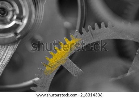 Black white metallic Background with golden spot on cogwheel a clockwork. For your successful business design. Macro.