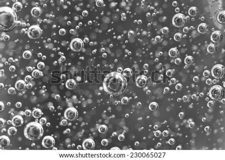 Air bubbles in water. Abstract black-and-white background. Macro photo, for your successful business design.