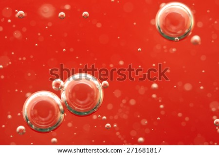 Air bubbles in a red liquid , concept such as medical research of blood and other your successful projects. Macro