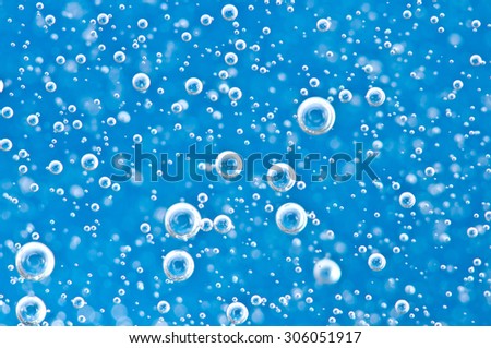 Macro Oxygen bubbles in blue clear water, concept such as ecology, environment, clean sea, potable water