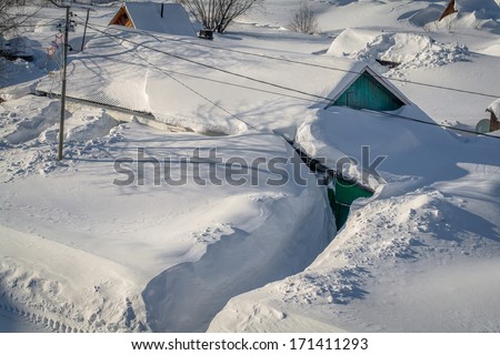 House in the winter covered in deep snow