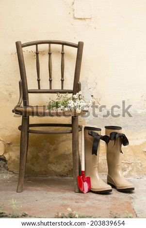 garden still life with gum boots and garden tools