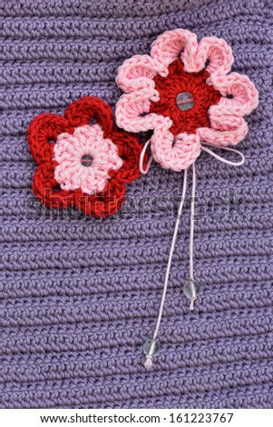 crochet flowers pink and white on a lavender background