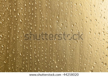 water drops on gold metal surface