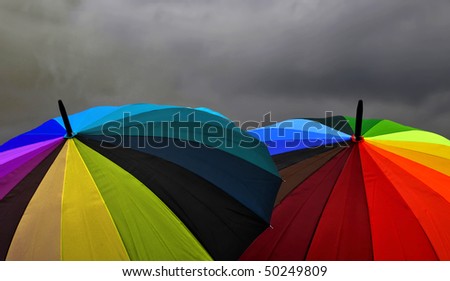 Rainbow Umbrellas Under Storm Clouds