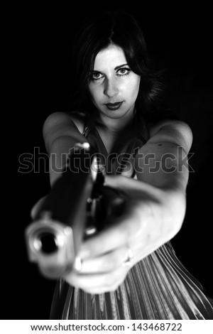 Beautiful sexy girl with gun isolated on black background