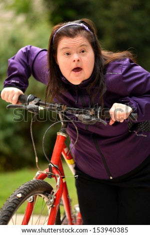 stock-photo-down-syndrome-woman-with-bicycle-153940385.jpg