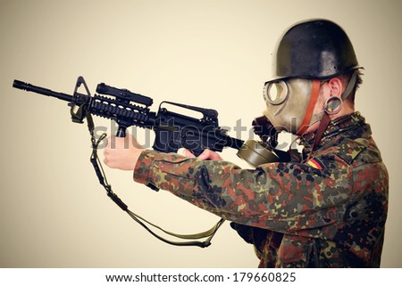 Soldier with gas mask and rifles against a white background