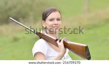 girl aiming a pneumatic rifle