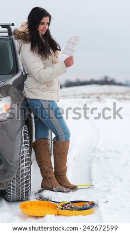 Similar – Image, Stock Photo Woman putting security snow chain in tire wheel of car