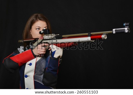 Woman training sport shooting with air rifle gun.