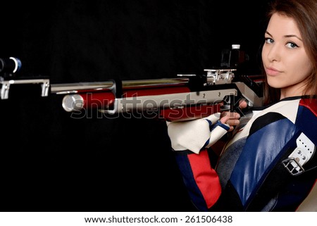 Woman training sport shooting with air rifle gun