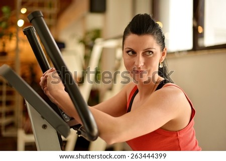 happy cutie athletic girl , execute exercise on sport-apparatus and smile, in sport-hall