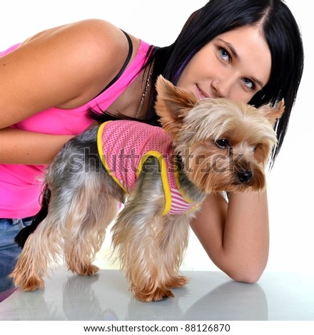 Beautiful young girl with cute yorkshire terrier dog, isolated on white.