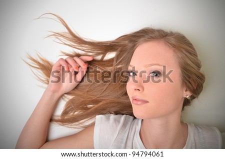 Pretty woman with long straight brown hair, isolated on white background