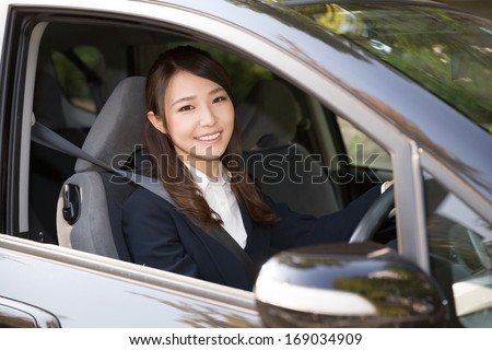 Beautiful young asian woman in a car