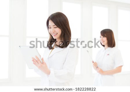 Young attractive asian nurse and doctor