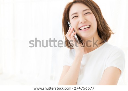 Beautiful young asian woman who talks on the telephone