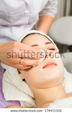 skin care, beautician applying face mask cream
