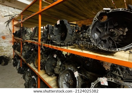 Used car parts on the store shelf. Used auto parts for sale in a store in a landfill. Transmissions for different kind of cars. Disassembly of cars. Foto stock © 
