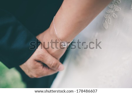 Young couple holding hands close-up  with retro filter effect