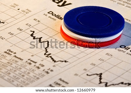 Red, white and blue poker chips over graph of  sinking dollar value