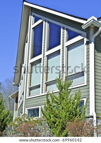 Exterior of a home with the shades down on some of the windows to reduce sun exposure or give privacy.
