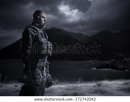 Soldier at dark. Military night under the light of the moon. Frustrated man.